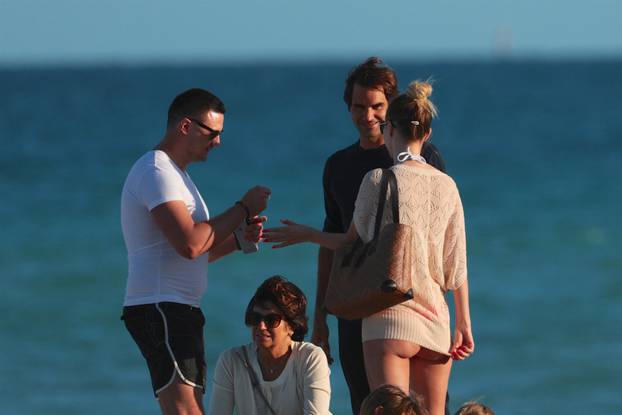 Roger Federer takes selfies with scantily clad woman