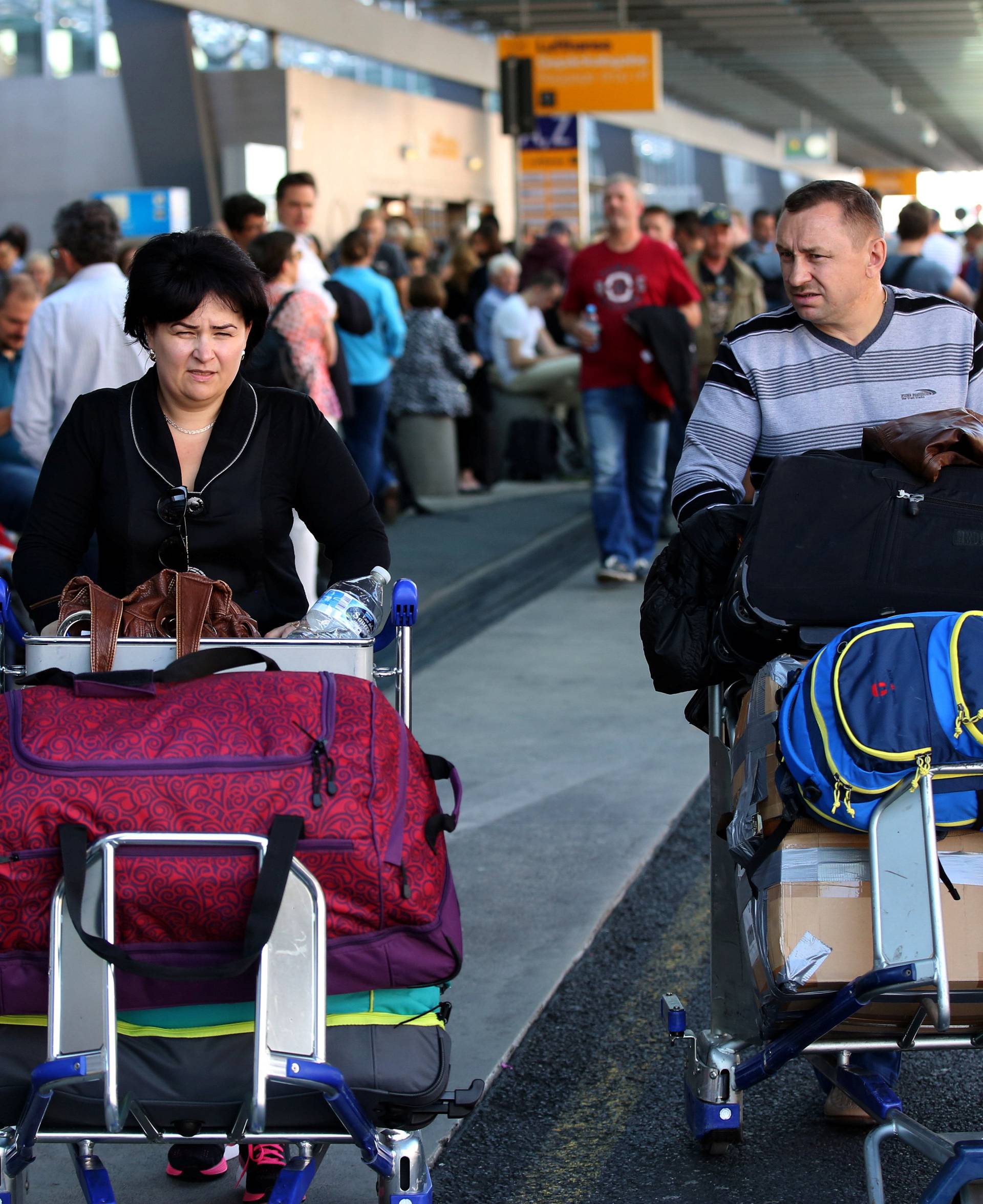 People gather outside Frankfurt airport terminal after Terminal 1 departure hall was evacuated in Frankfurt,