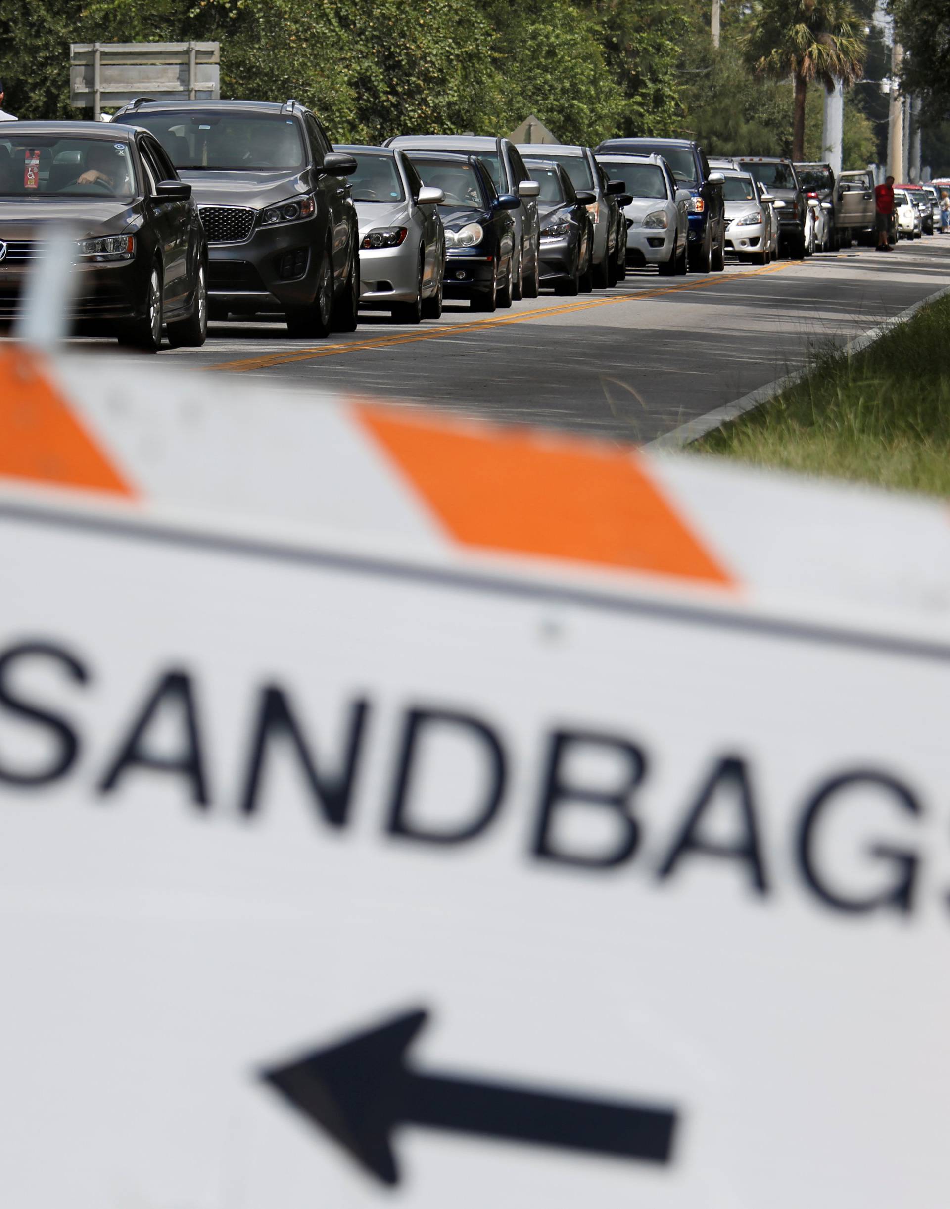 Motorists form long queue to get sandbags at Kissimmee, in preparation for the arrival of Hurricane Irma making landfall, in Florida