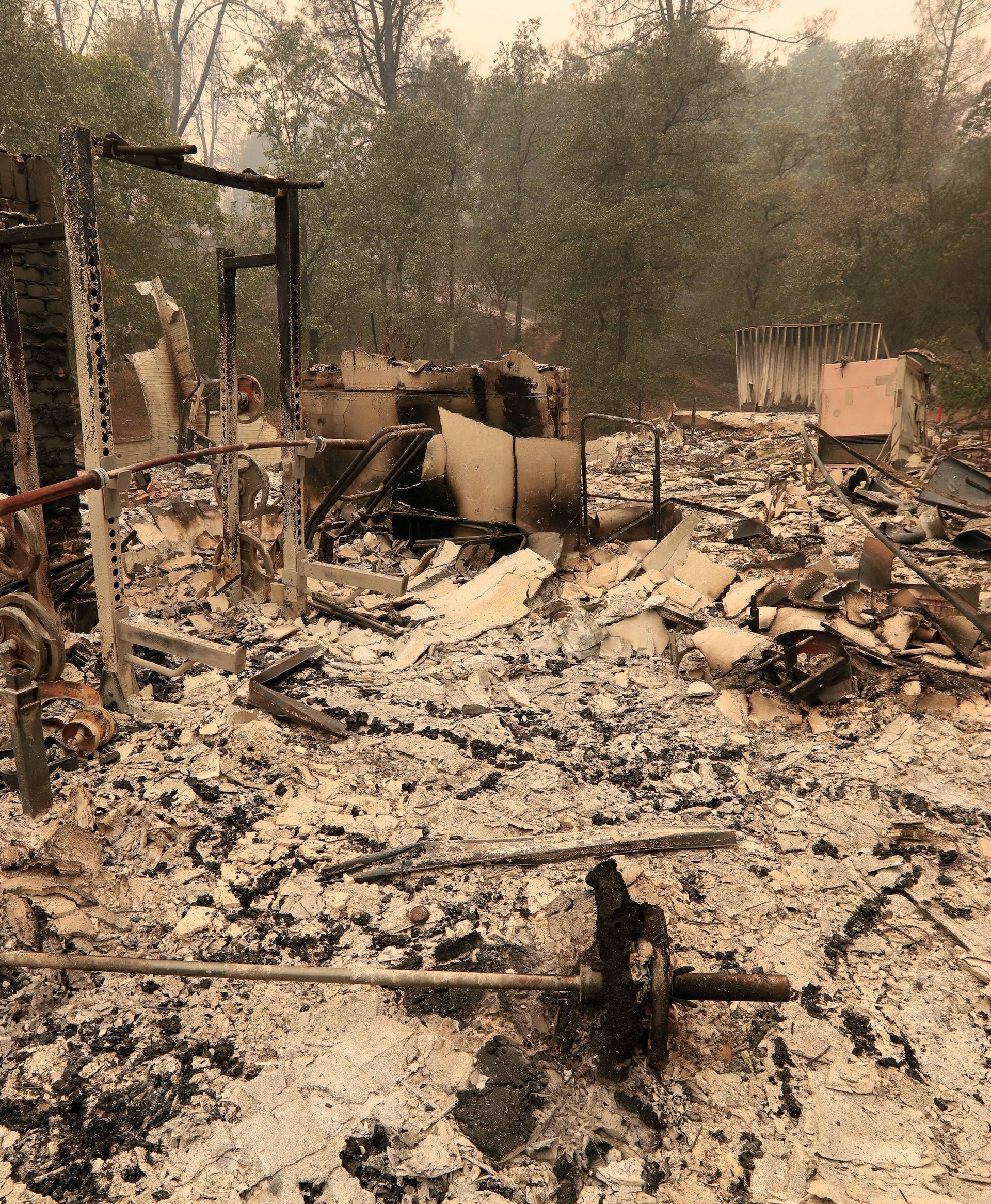The debris of a burned home is seen after the Carr Fire west of Redding