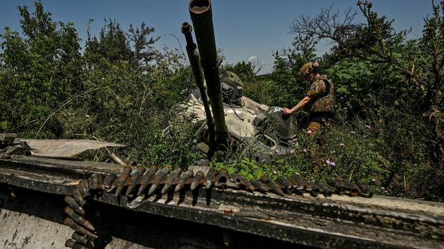 FILE PHOTO: Ukrainian serviceman inspects a turret of a destroyed Russian BMP-3 infantry fighting vehicle in the village of Novodarivka, Ukraine