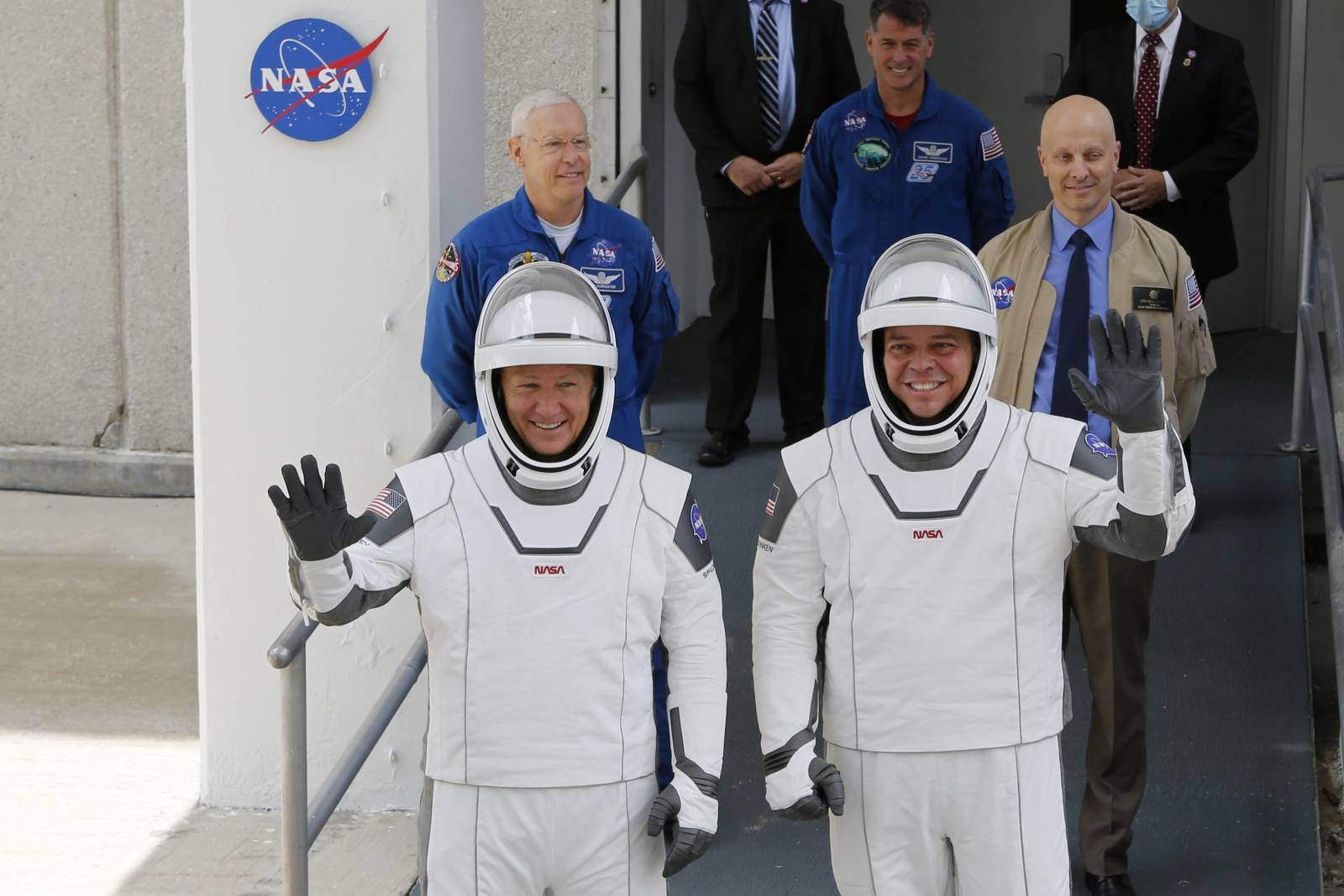 NASA astronauts Douglas Hurley and Robert Behnken wave as they head to Pad39A before the launch of a SpaceX Falcon 9 rocket and Crew Dragon spacecraft at the Kennedy Space Center, in Cape Canaveral