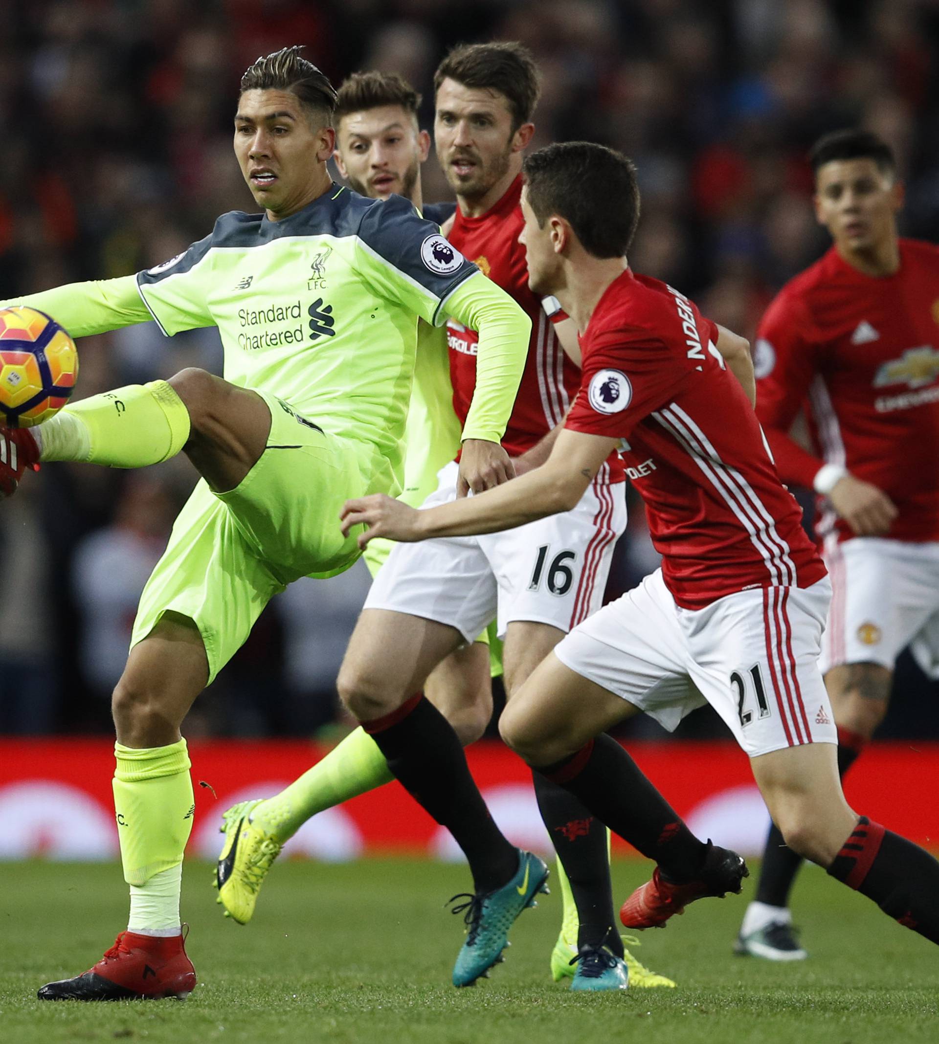 Liverpool's Roberto Firmino in action with Manchester United's Ander Herrera