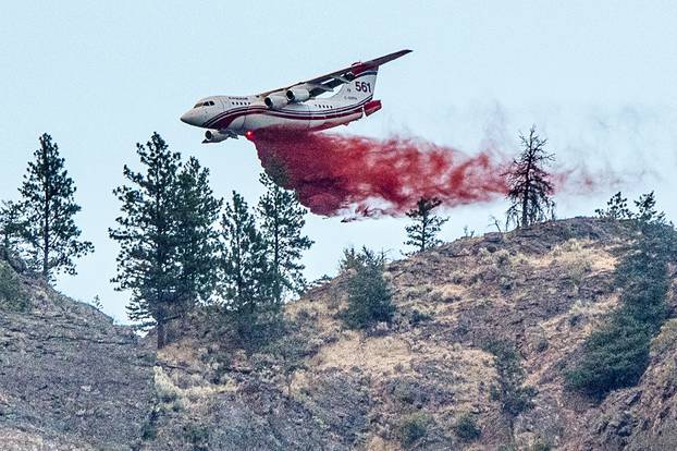 Conair airtanker drops fire retardant on part of the Nk