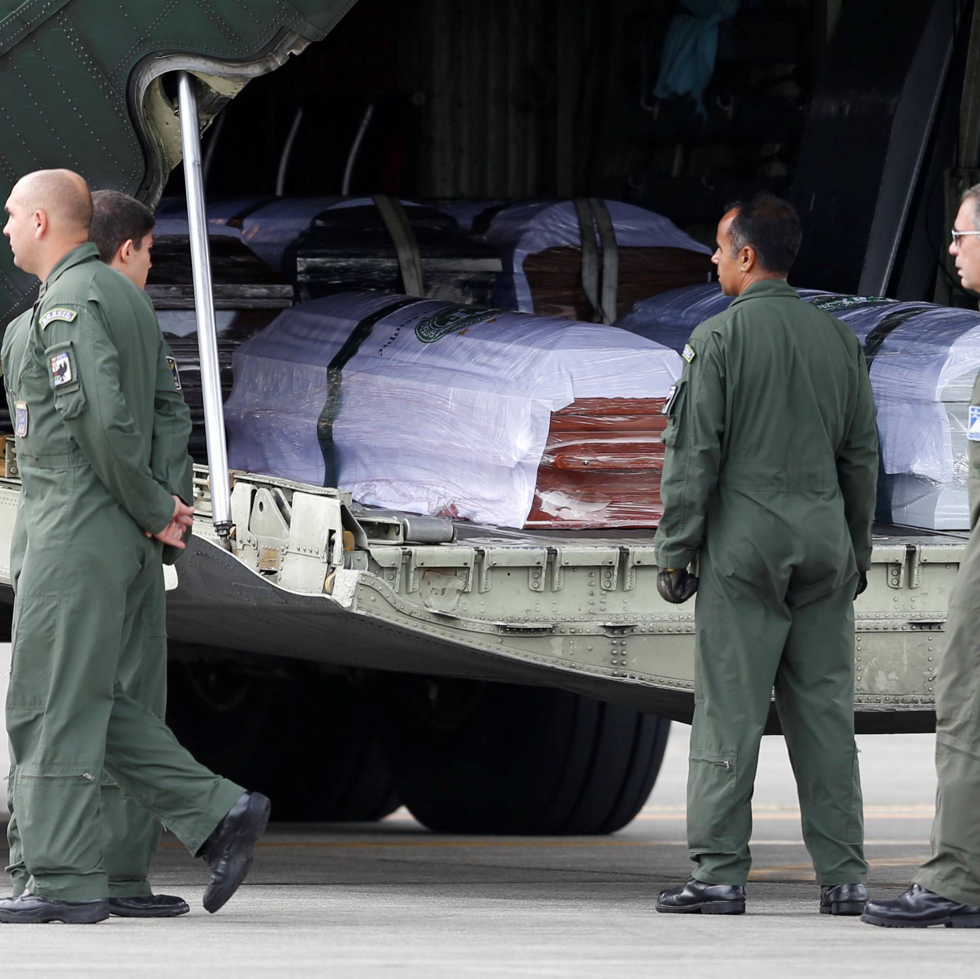 Coffins with the remains of Brazilian victims who died in an accident of the plane that crashed into the Colombian jungle with Brazilian soccer team Chapecoense are pictured, at the airport from where the bodies will be flown home to Brazil, in Medellin