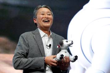Kazuo Hirai, president and CEO of Sony Corporation, holds an Aibo robotic dog during a news conference at the 2018 CES in Las Vegas