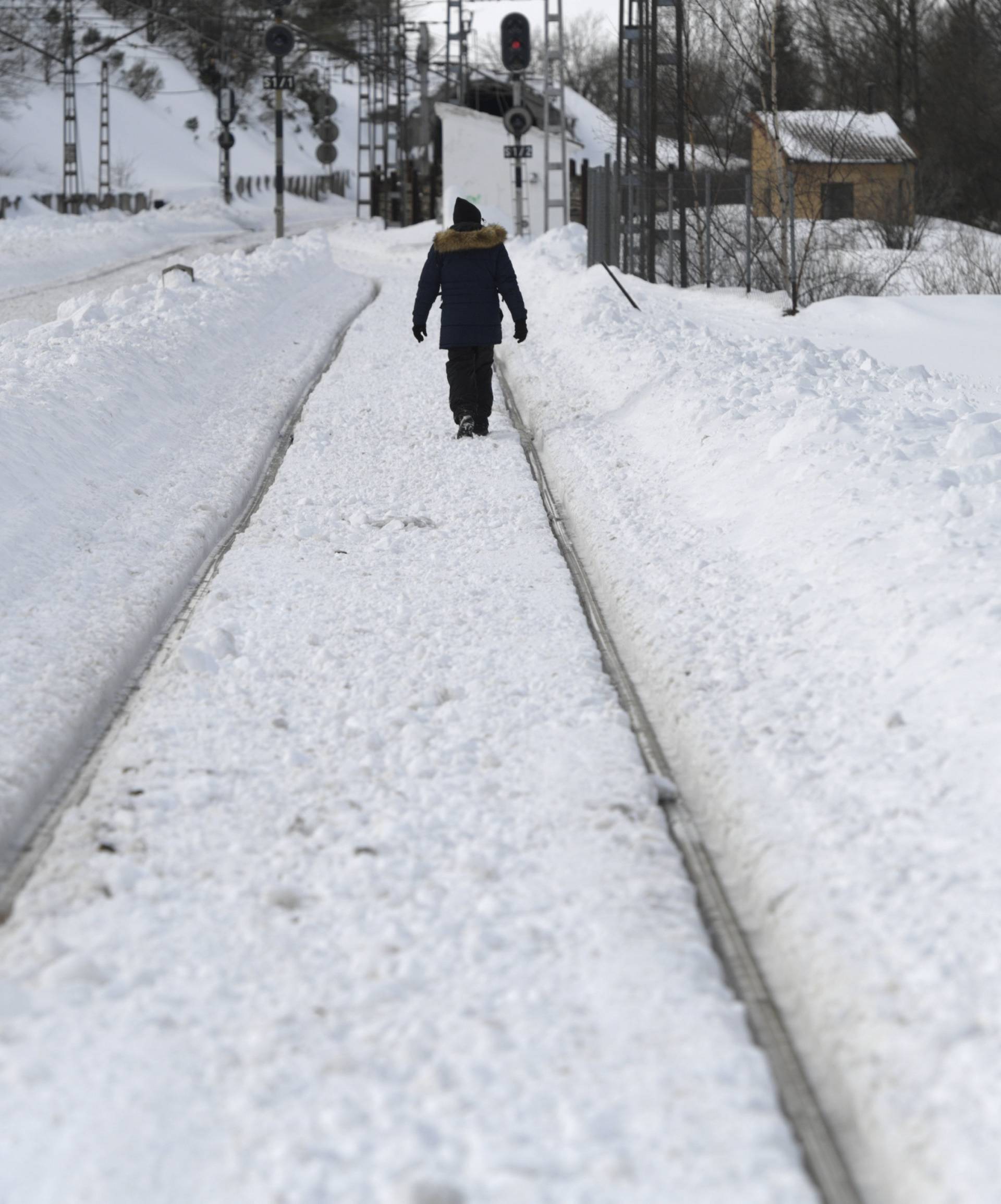 A man walks on the train tracks in Busdongo