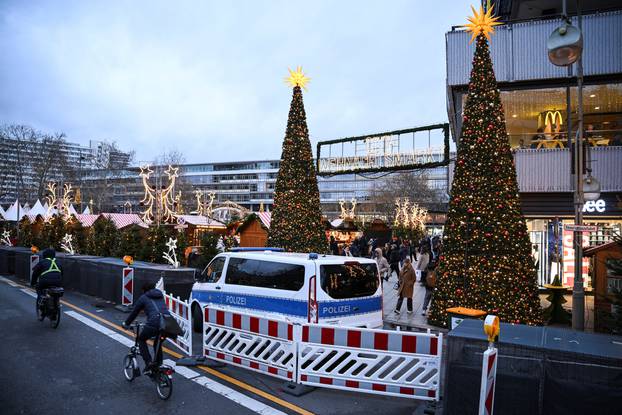 A police car secures an entrance of the Christmas market on the Breitscheidplatz, in Berlin