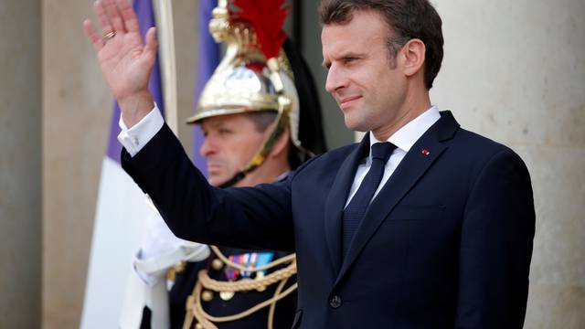 FILE PHOTO: French President Emmanuel Macron waves at the Elysee Palace in Paris