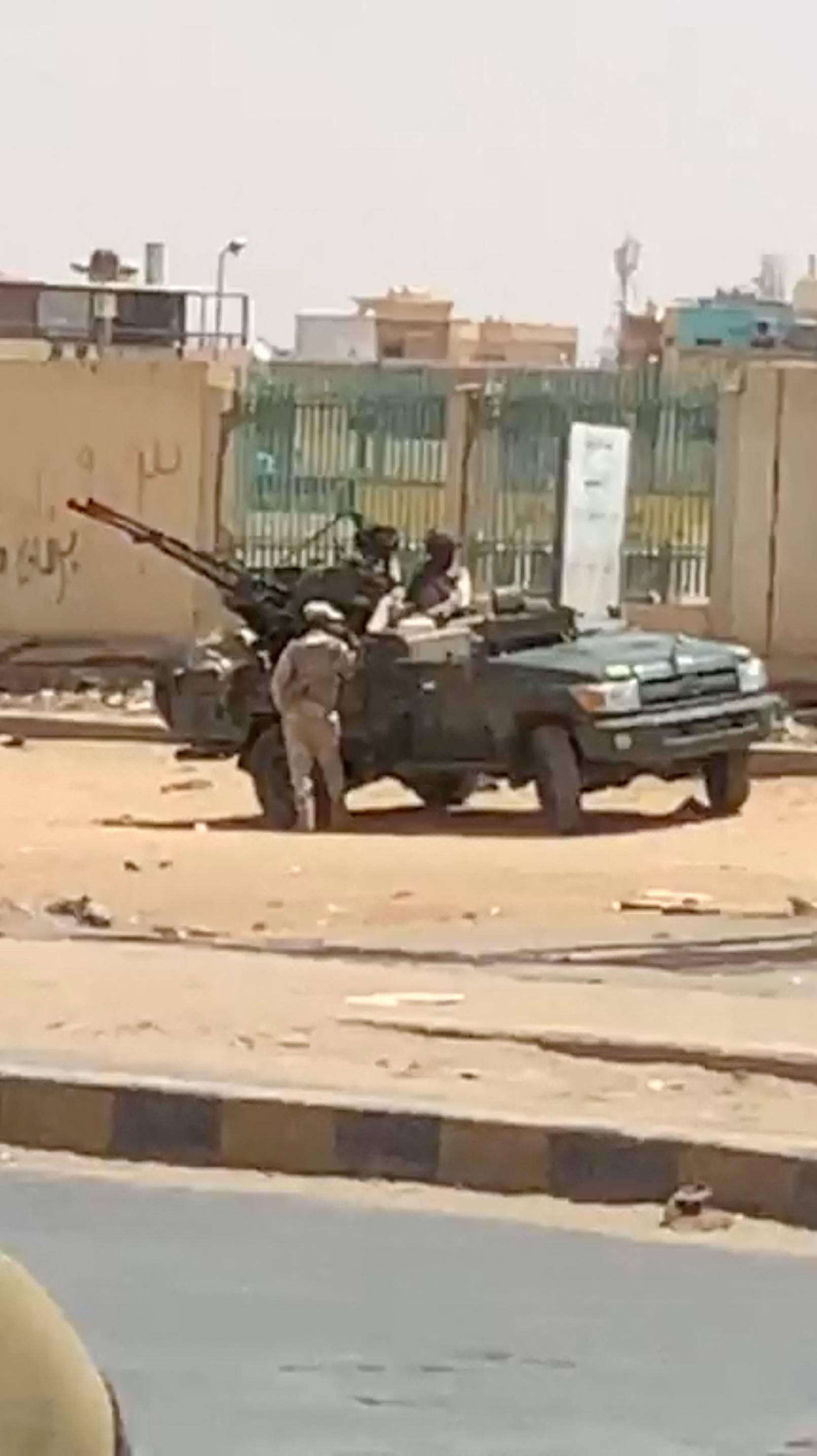 Military vehicle and soldiers on a street of Khartoum