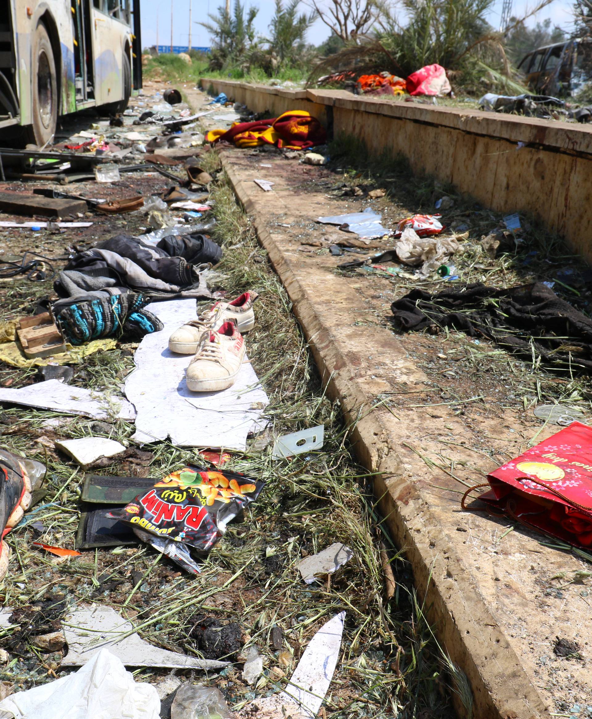 Scattered shoes lie on the ground near damaged buses after an explosion yesterday at insurgent-held al-Rashideen