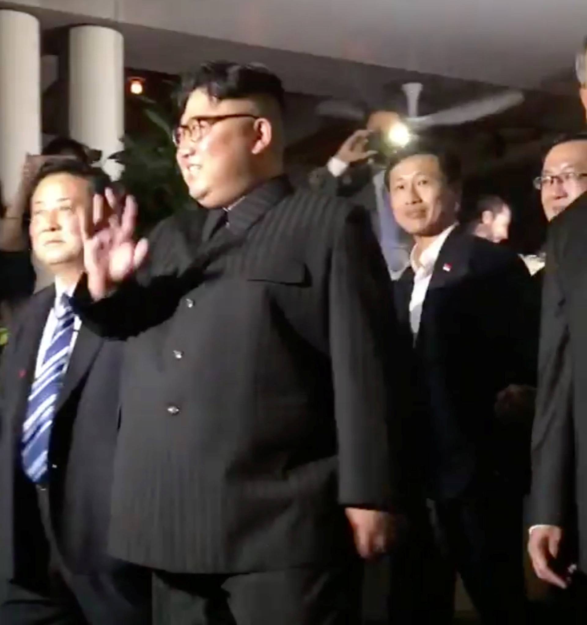 North Korea's leader Kim Jong Un waves to the crowd in Singapore