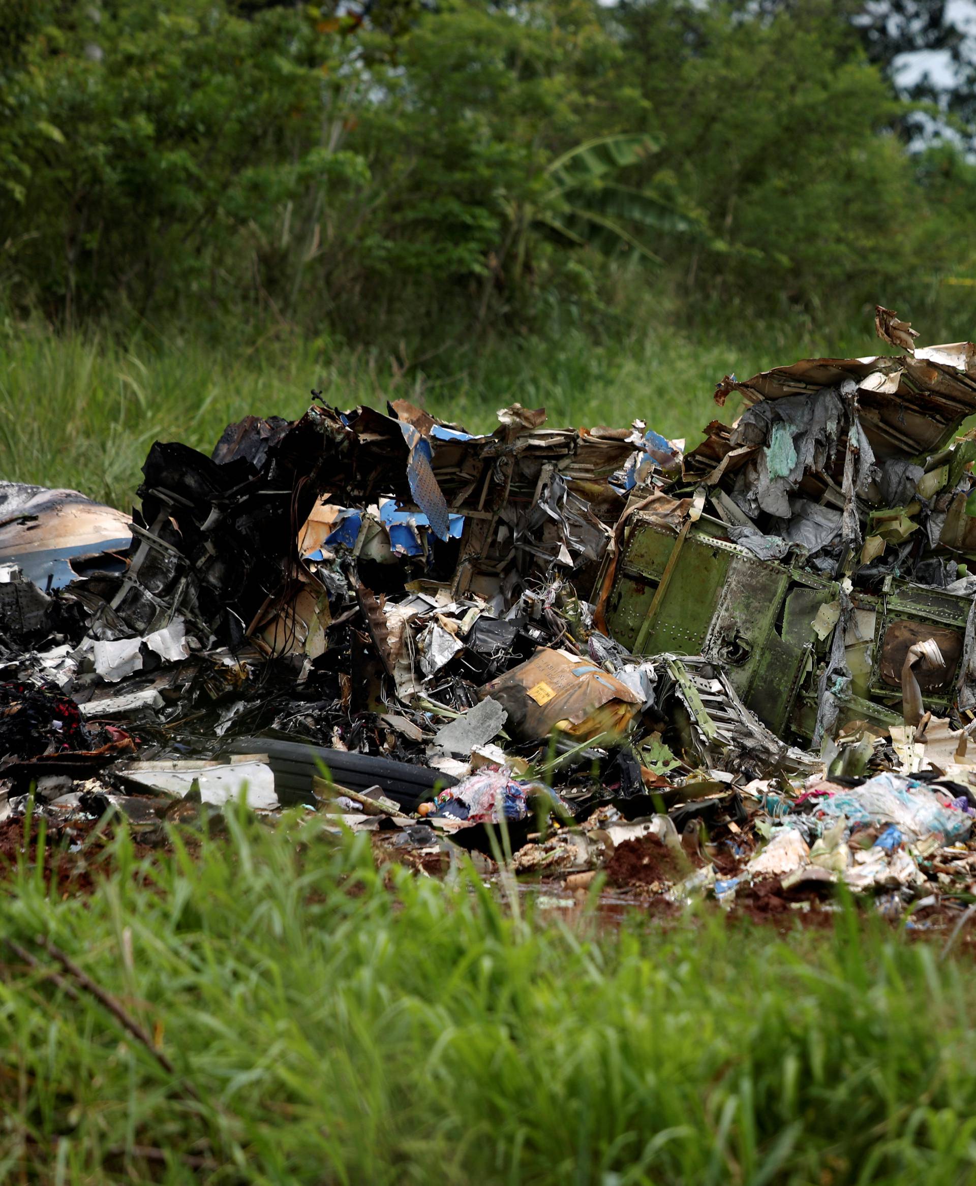 Rescue team members work on the wreckage of a Boeing 737 plane that crashed  in the agricultural area of Boyeros