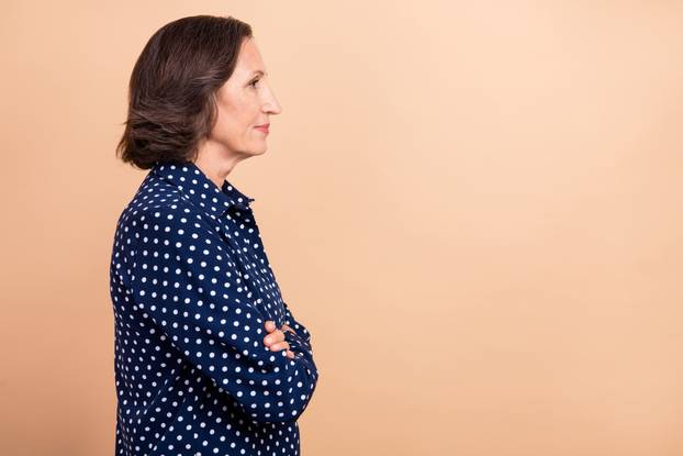 Profile photo of manager old brunette lady crossed palms look empty space wear blue shirt isolated on beige color background