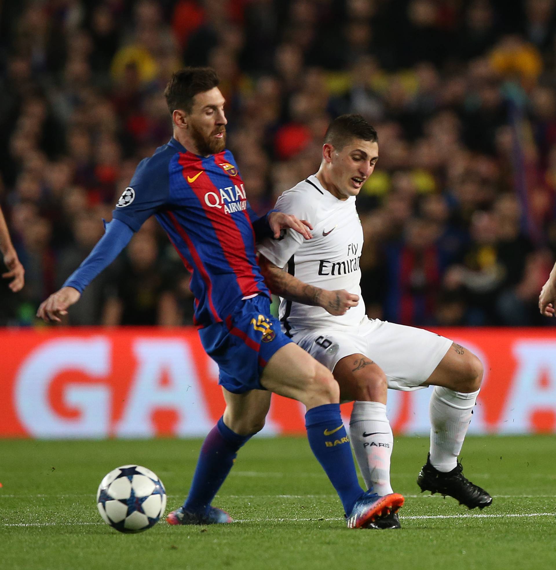 Barcelona's Lionel Messi in action with Paris Saint-Germain's Marco Verratti