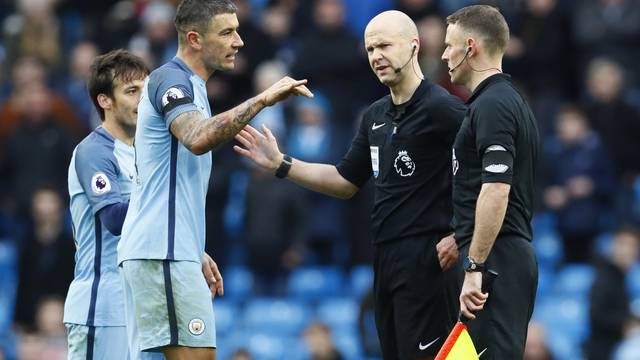 Manchester City's Aleksandar Kolarov with referee Anthony Taylor at the end of the match