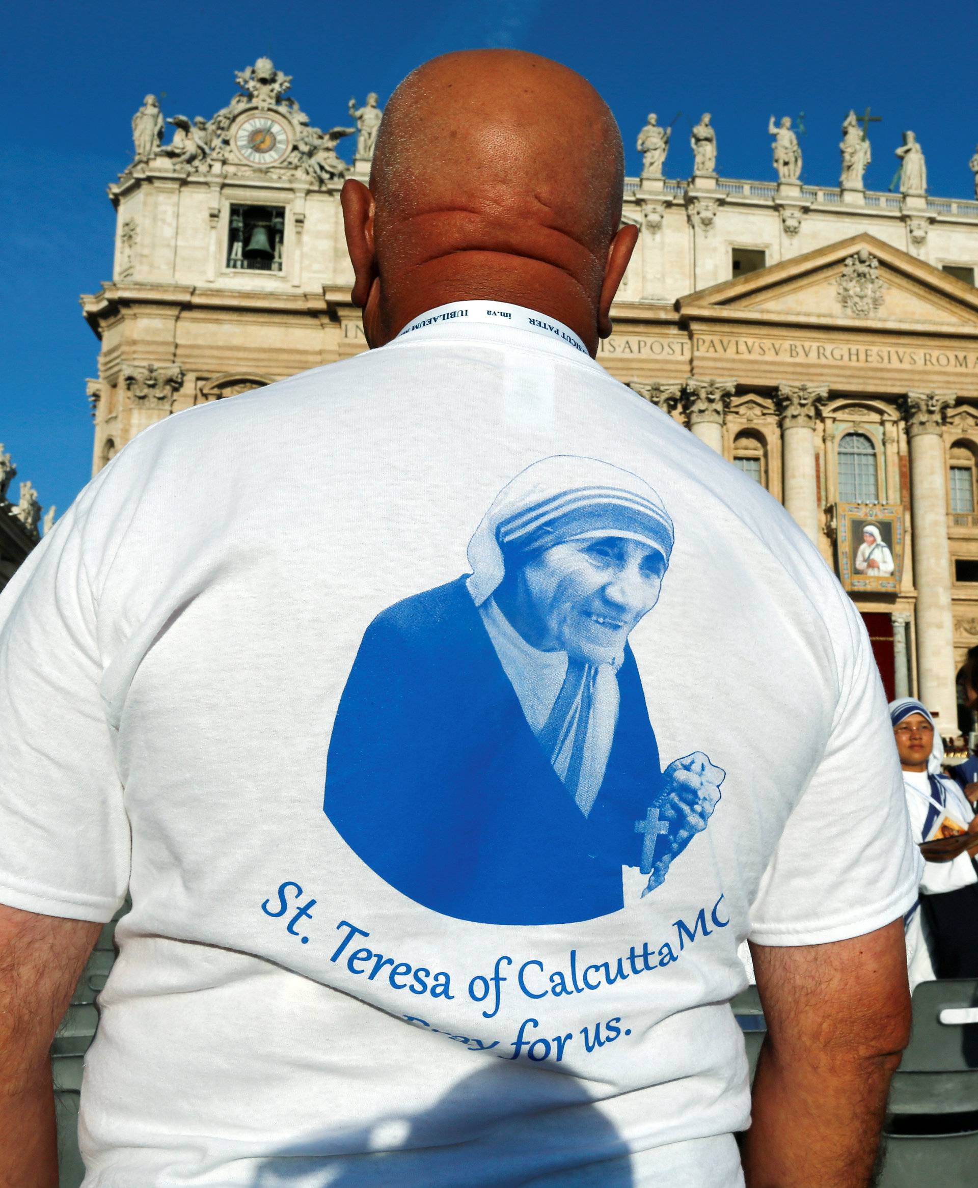 A man wears a t-shirt with the image of Mother Teresa of Calcutta before a mass celebrated by Pope Francis for her canonisation in Saint Peter's Square at the Vatican 