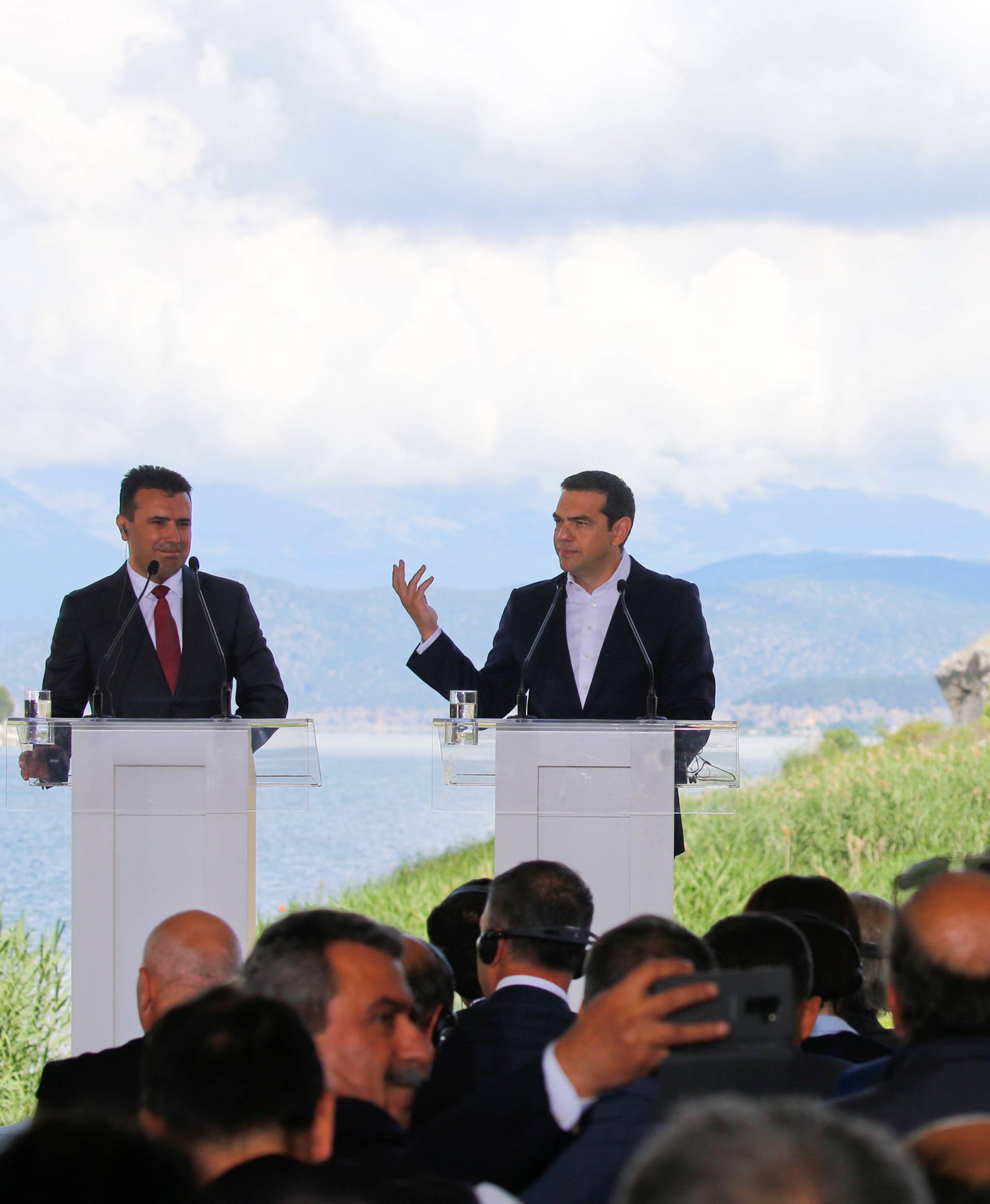 Greek Prime Minister Alexis Tsipras and Macedonian Prime Minister Zoran Zaev speak before the signing of an accord to settle a long dispute over the former Yugoslav republic's name in the village of Psarades