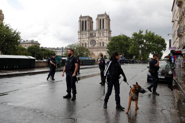 French police stand at the scene of a shooting incident near the Notre Dame Cathedral in Paris