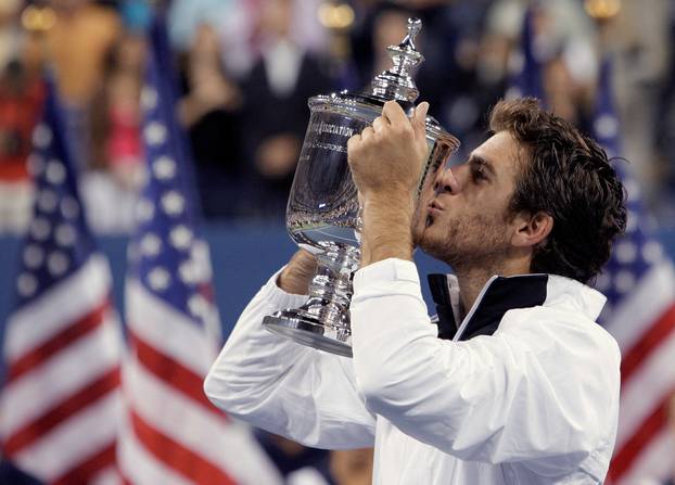FILE PHOTO: Juan Martin del Potro of Argentina kisses the champions trophy after defeating Roger Federer of Switzerland in the men's final at the U.S. Open