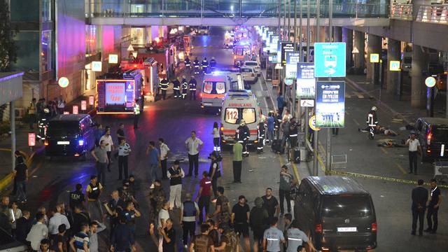 People walk outside Turkey's largest airport, Istanbul Ataturk following a blast