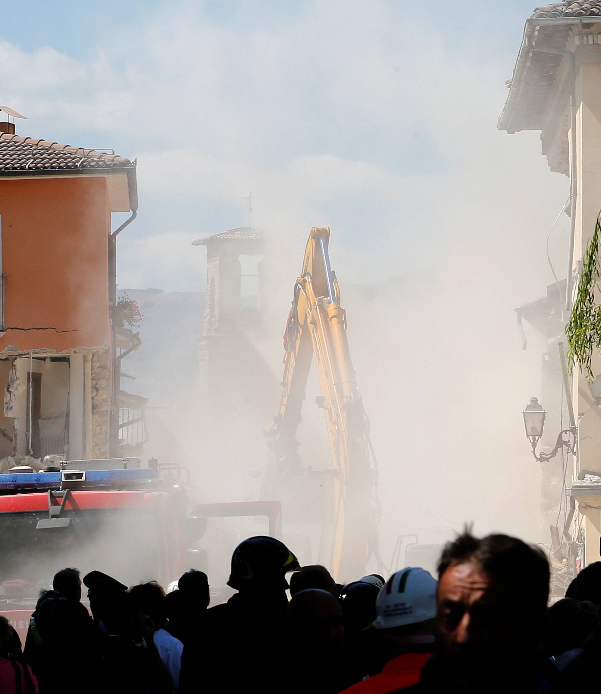 Dust is seen coming out from falling rubble following an aftershock in Amatrice