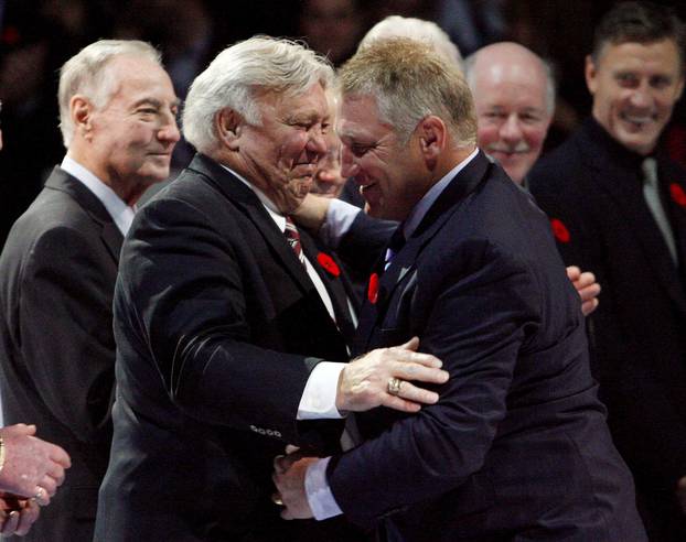 FILE PHOTO: Former NHL star Hull embraces his son Brett during an on-ice ceremony to introduce the Hockey Hall of Fame 2009 inductees in Toronto