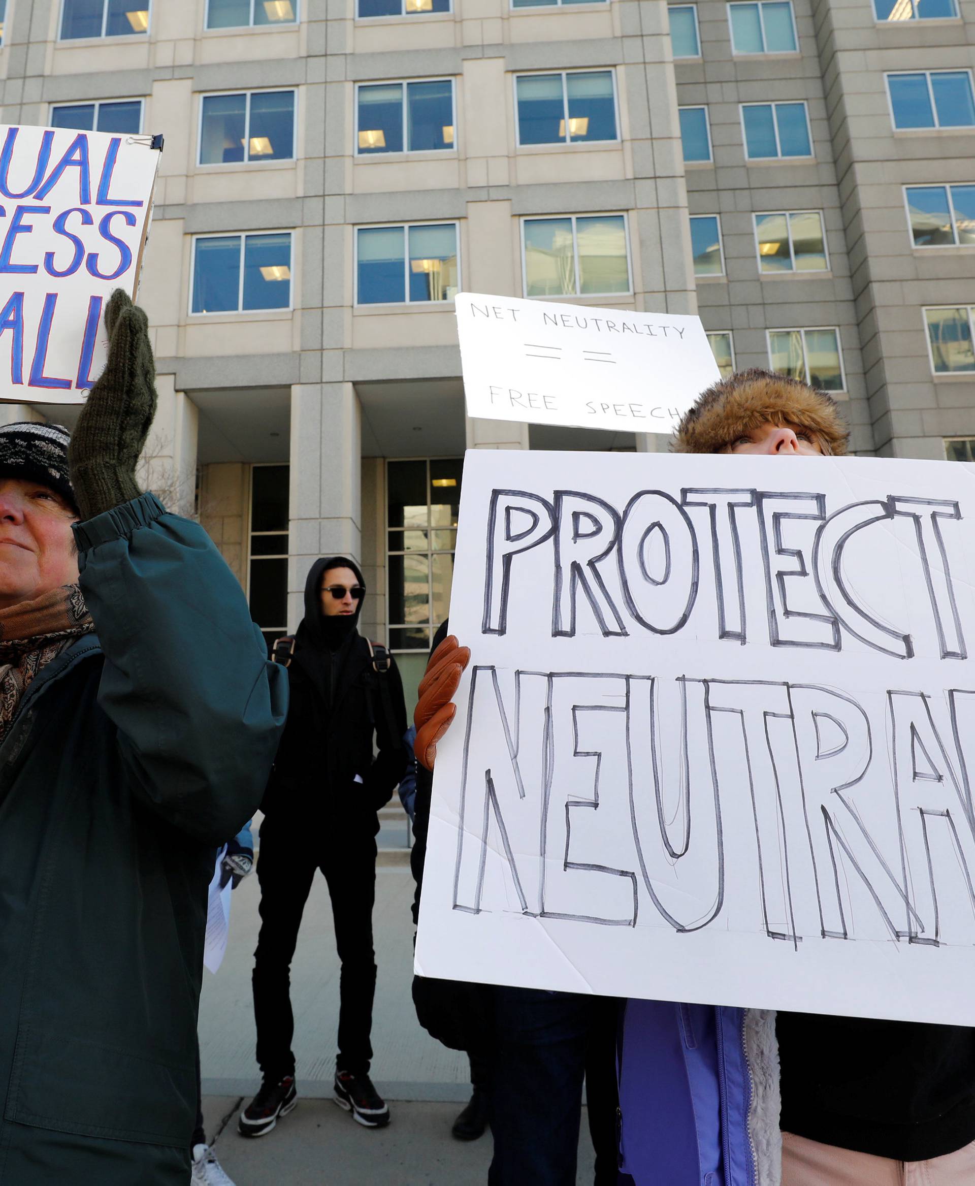 Net neutrality advocates rally in front of the Federal Communications Commission in Washington