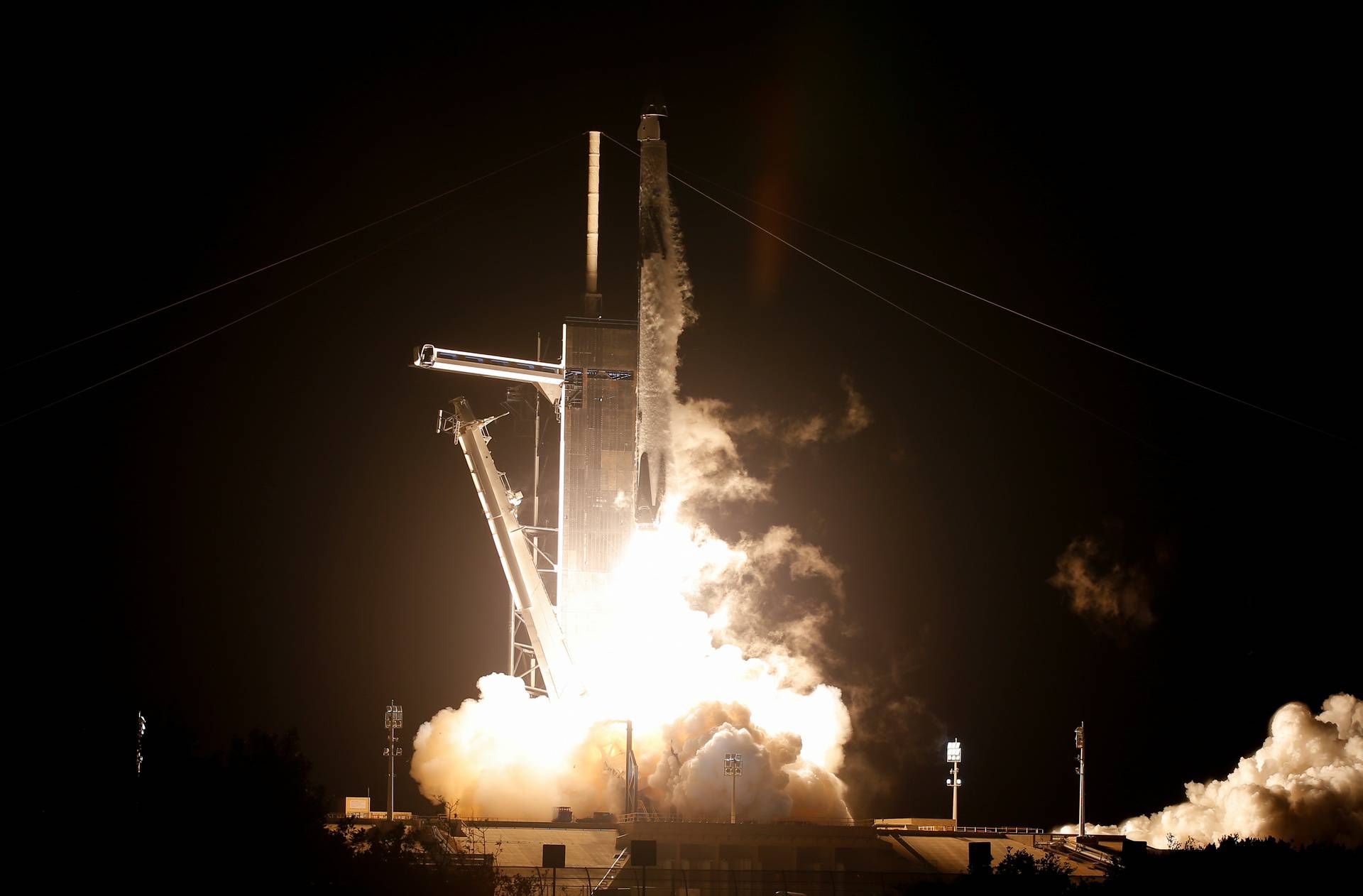 A SpaceX Falcon 9 rocket, topped with the Crew Dragon capsule, is launched carrying four astronauts on the first operational NASA commercial crew mission at Kennedy Space Center in Cape Canaveral, Florida