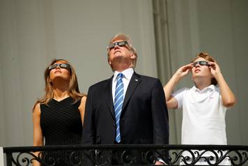 U.S. President Trump watches the solar eclipse with first Lady Melania Trump and son Barron from the Truman Balcony at the White House in Washington