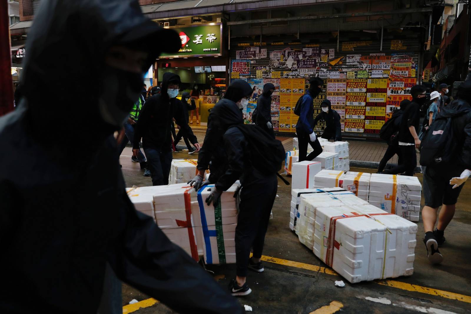 Anti-government protesters place objects on the road during a protest at Mong Kok in Hong Kong