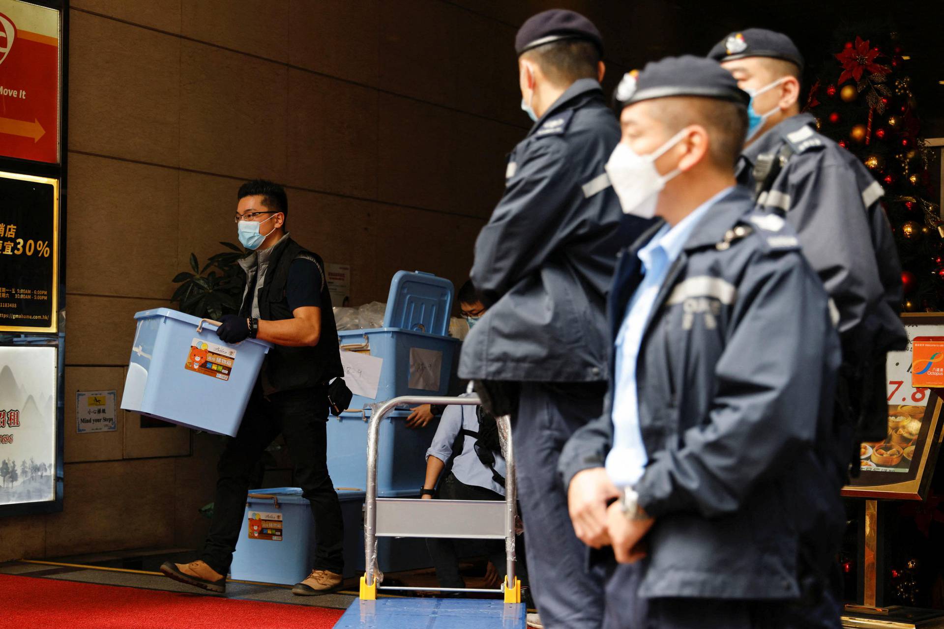 A police collects a box of evidence after a police search at the office of Stand News, in Hong Kong