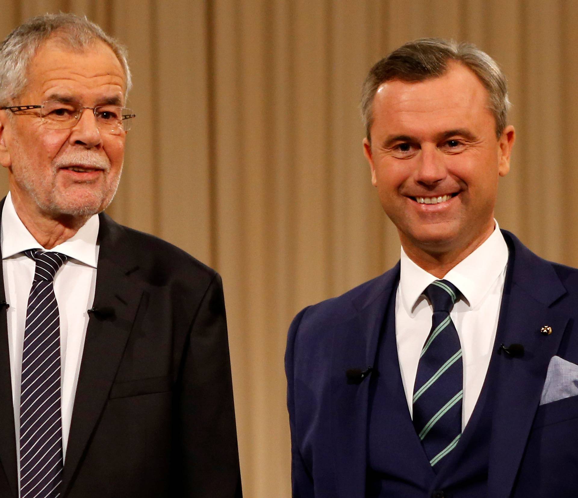 Austrian presidential candidate Van der Bellen, who is supported by the Greens, and Hofer of the FPOe pose for photographers before a TV discussion in Vienna