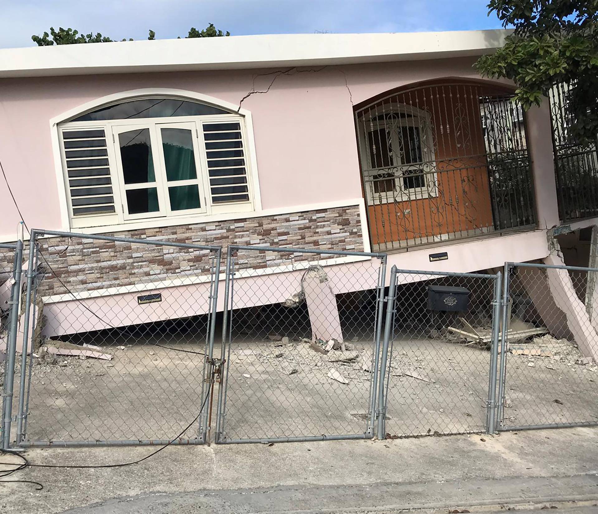 A house is seen collapsed on its foundation after an earthquake in Guanica