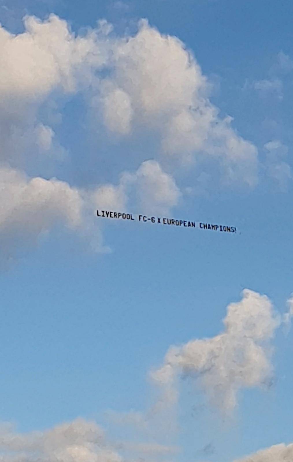 A banner carried by the plane that reads: "Liverpool: 6x European champions" is spotted over the WACA stadium, during the Manchester United training in Perth
