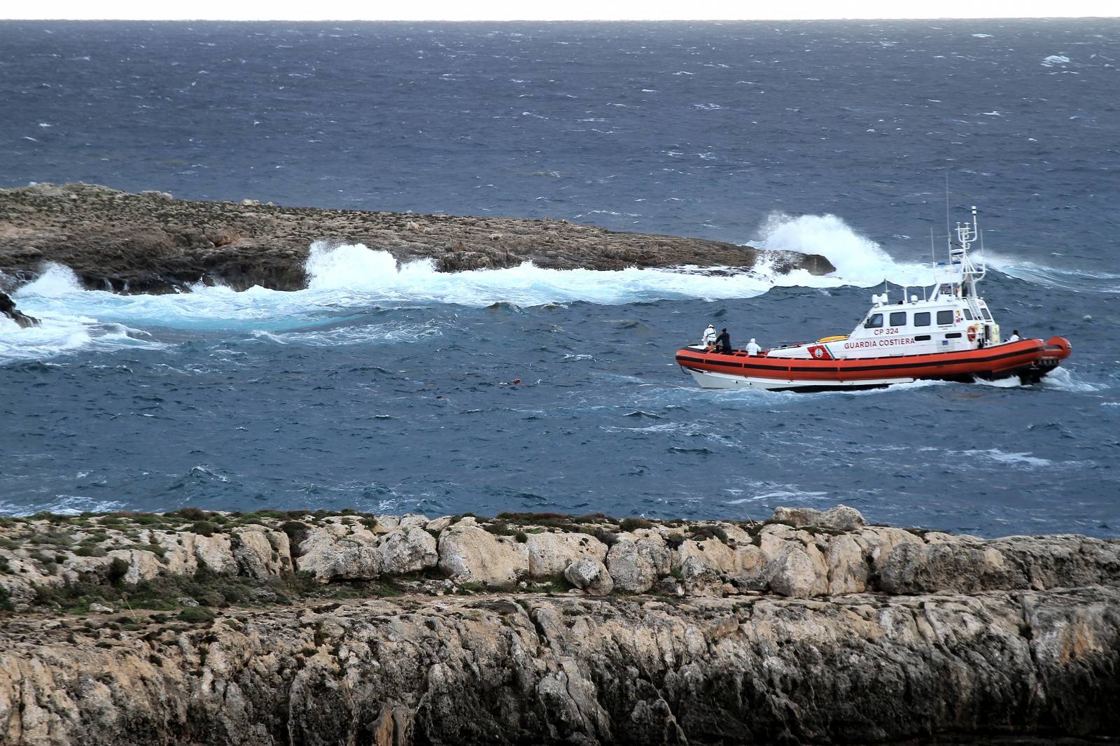 An Italian coastguard boat is seen at sea where a migrant boat capsized off the Italian coast, on the island of Lampedusa