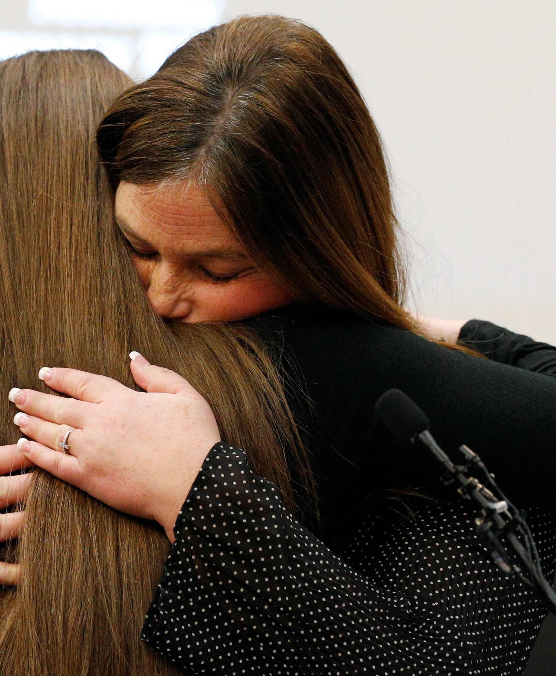 Victim Emma Ann Miller is embraced by her mother Leslie Miller at the sentencing hearing for Larry Nassar, a former team USA Gymnastics doctor who pleaded guilty in November 2017 to sexual assault charges, in Lansing
