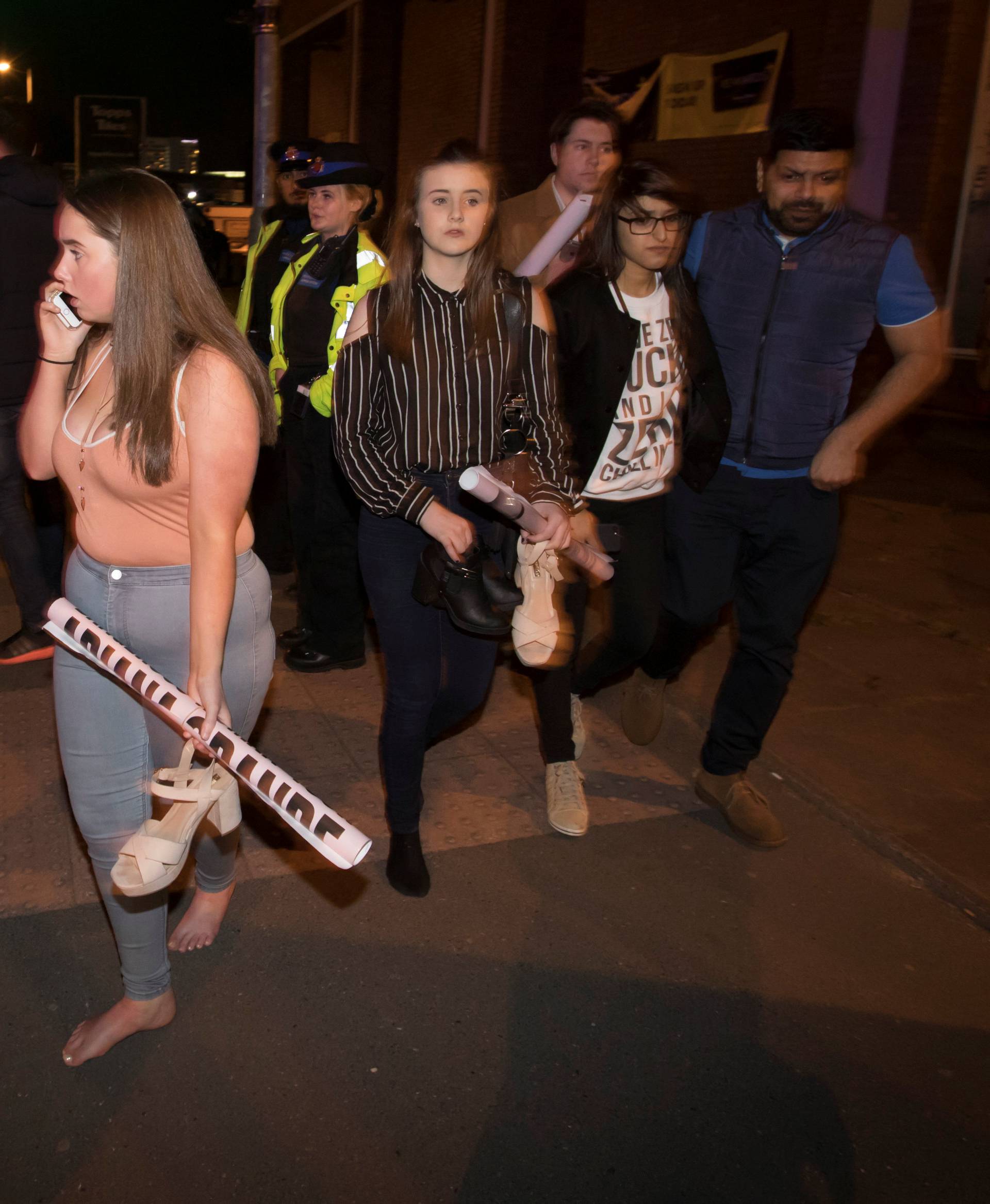 Concert goers react after fleeing the Manchester Arena in northern England where U.S. singer Ariana Grande had been performing in Manchester