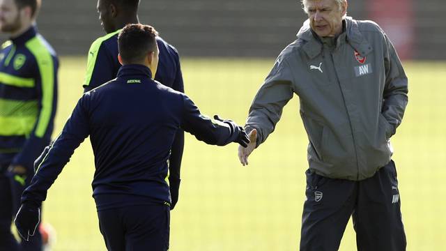 Arsenal manager Arsene Wenger shakes hands with Arsenal's Alexis Sanchez during training
