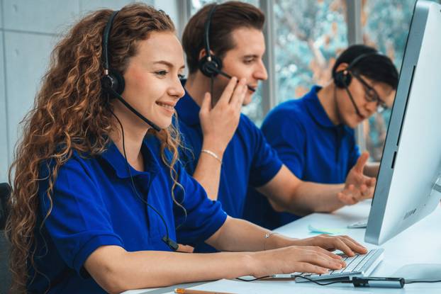 Business people wearing headset working in office Jivy