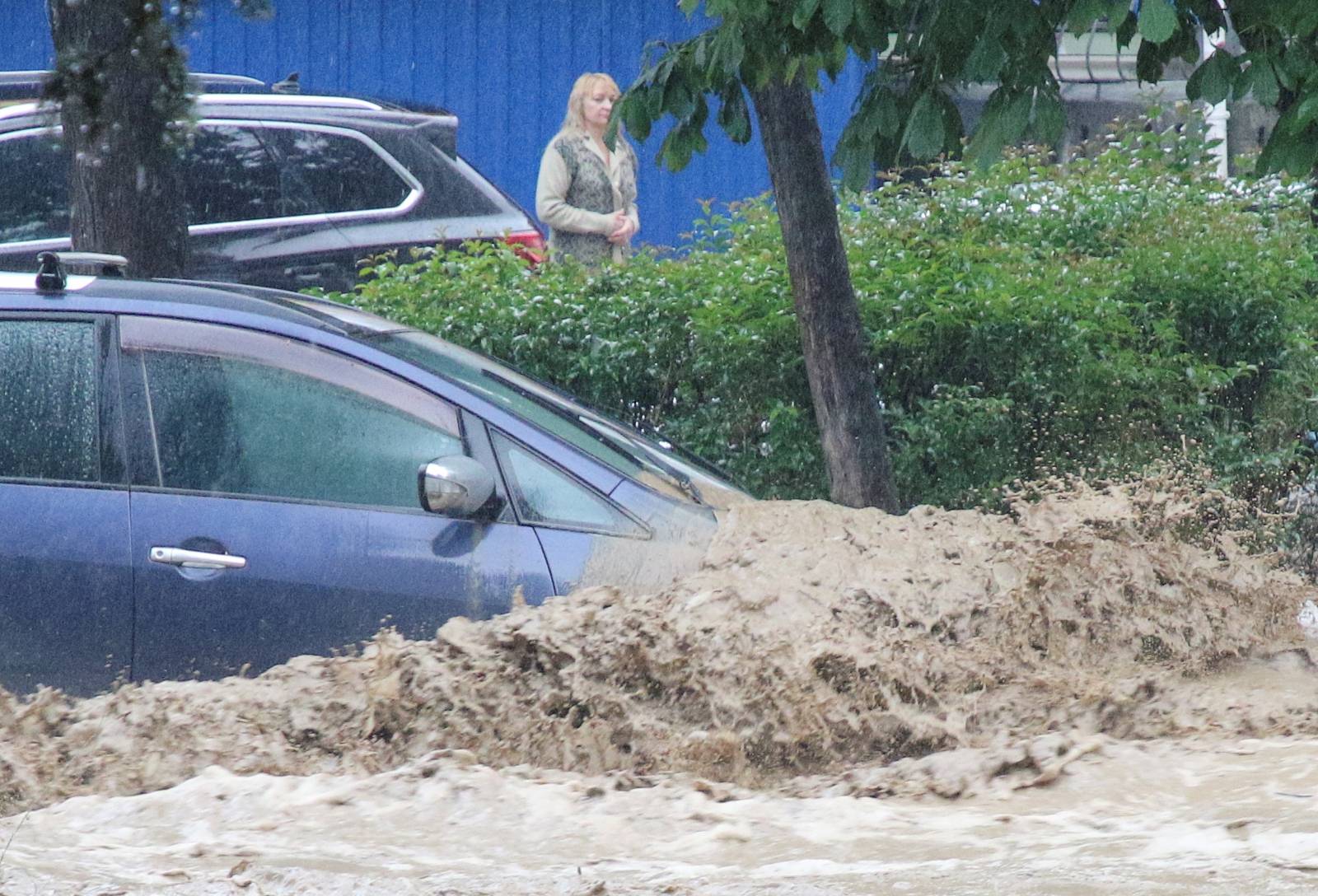 A car is parked in a flooded street following heavy rainfall in Yalta