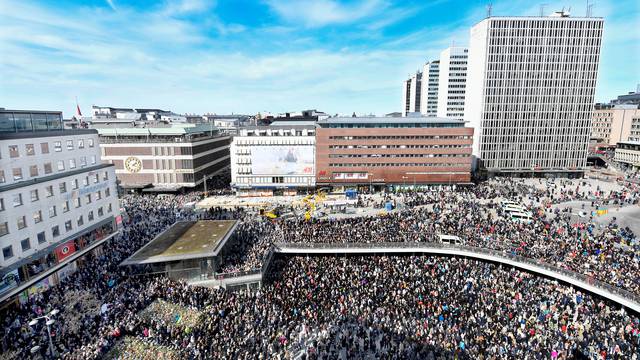 People gather in Sergels Torg, central Stockholm for a "Lovefest" vigil against terrorism following Friday's terror attack on Drottninggatan