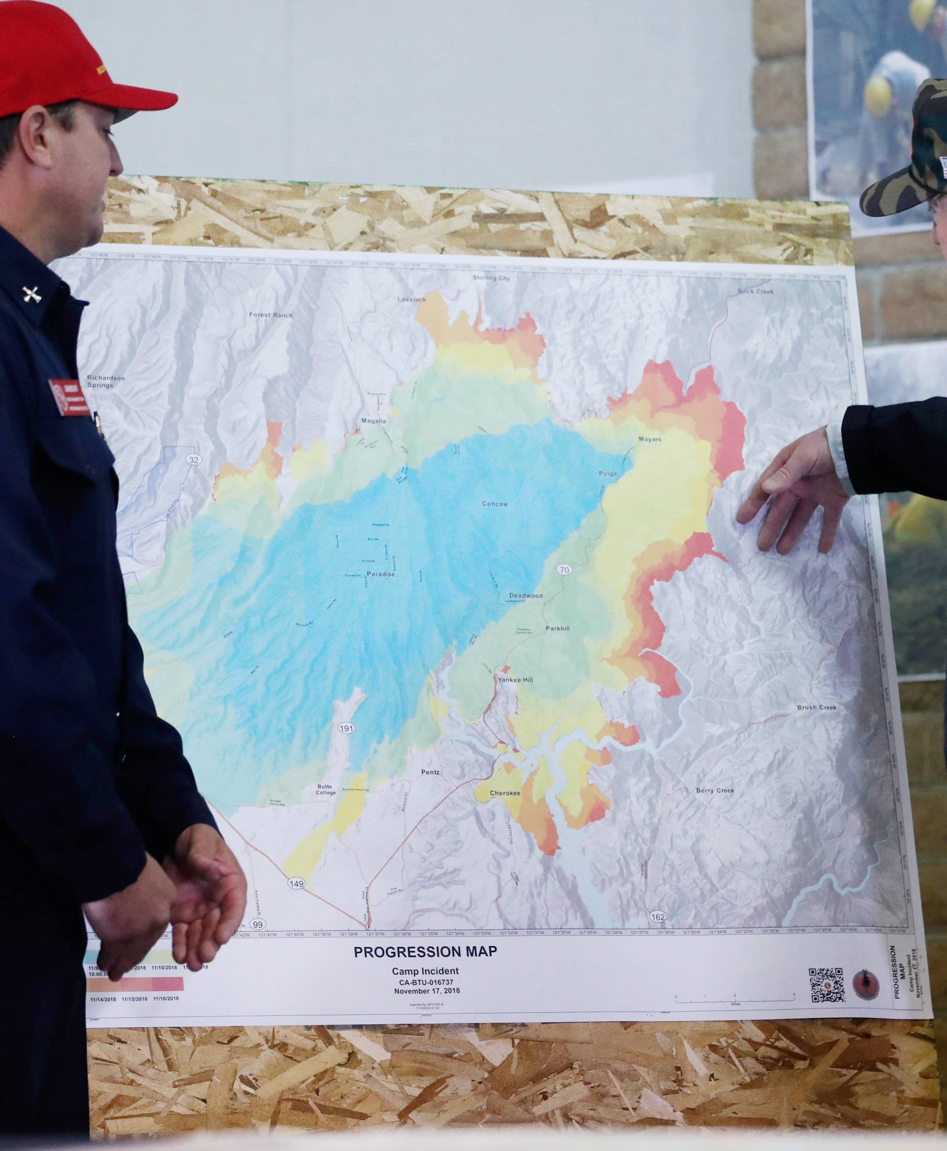President Donald Trump views the map with Josh Bischof after visiting the charred wreckage of in Paradise California