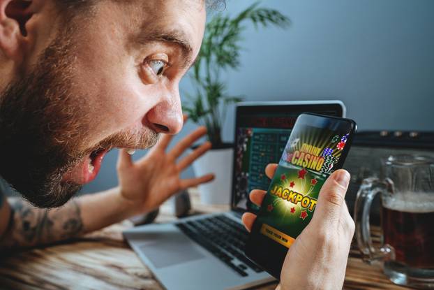 Lucky,Man,Celebrating,Victory,After,Winning,Jackpot,In,Online,Casino.