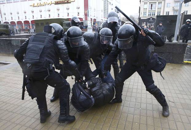 Law enforcement officers detain a participant of a rally marking the anniversary of the proclamation of the Belarussian People