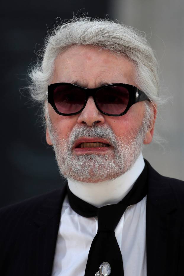 German designer Karl Lagerfeld appears at the end of his Haute Couture Fall/Winter 2018/2019 collection show for fashion house Chanel at the Grand Palais in Paris