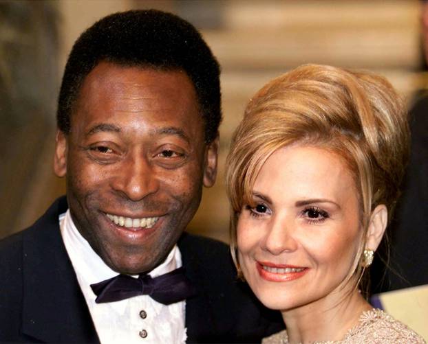 FILE PHOTO: Brazilian soccer legend Pele smiles next to his then-wife Assiria Nascimento as he enters Vienna's State Opera