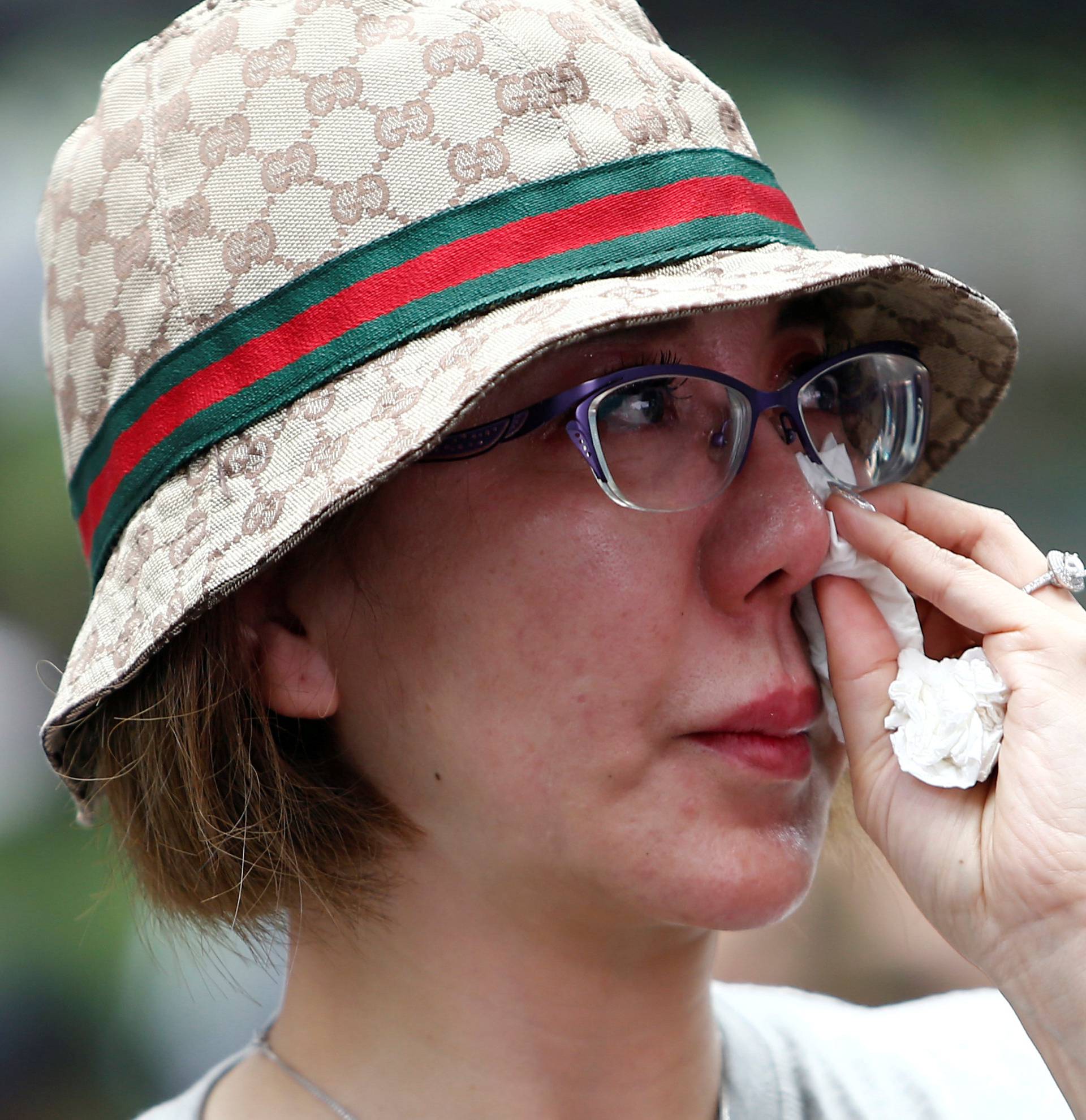 Family member wipes her tears away during fourth annual remembrance event for missing MH370, in Kuala Lumpur