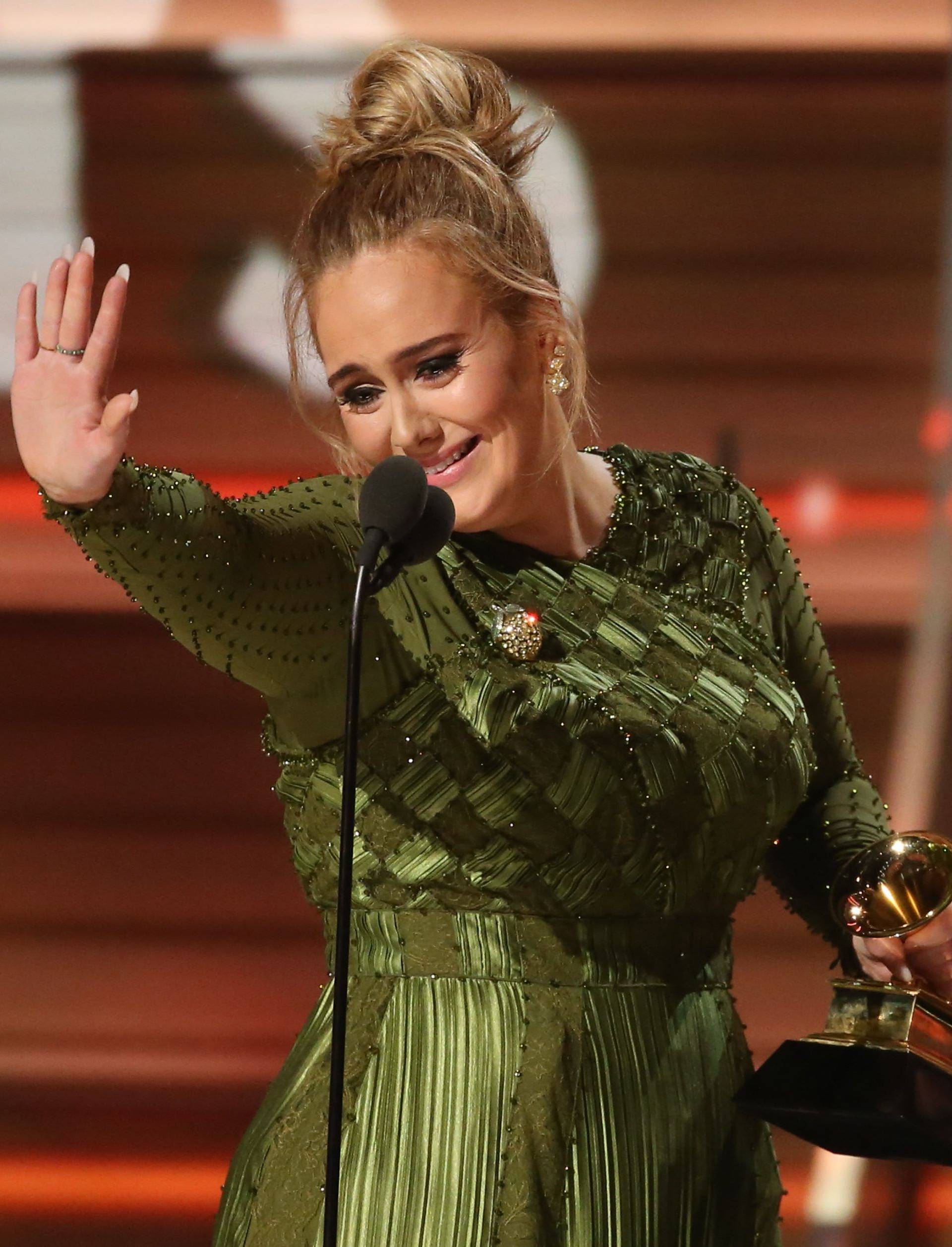 Adele and co-song writer Kurstin accept the Grammy for Song of the Year for "Hello" at the 59th Annual Grammy Awards in Los Angeles