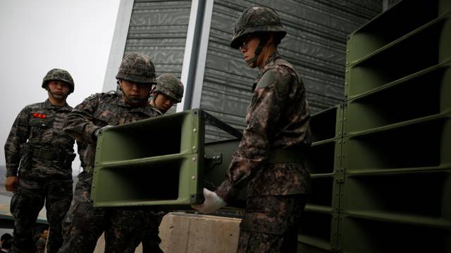 South Korean soldiers dismantle loudspeakers that were set up for propaganda broadcasts near the demilitarized zone separating the two Koreas in Paju